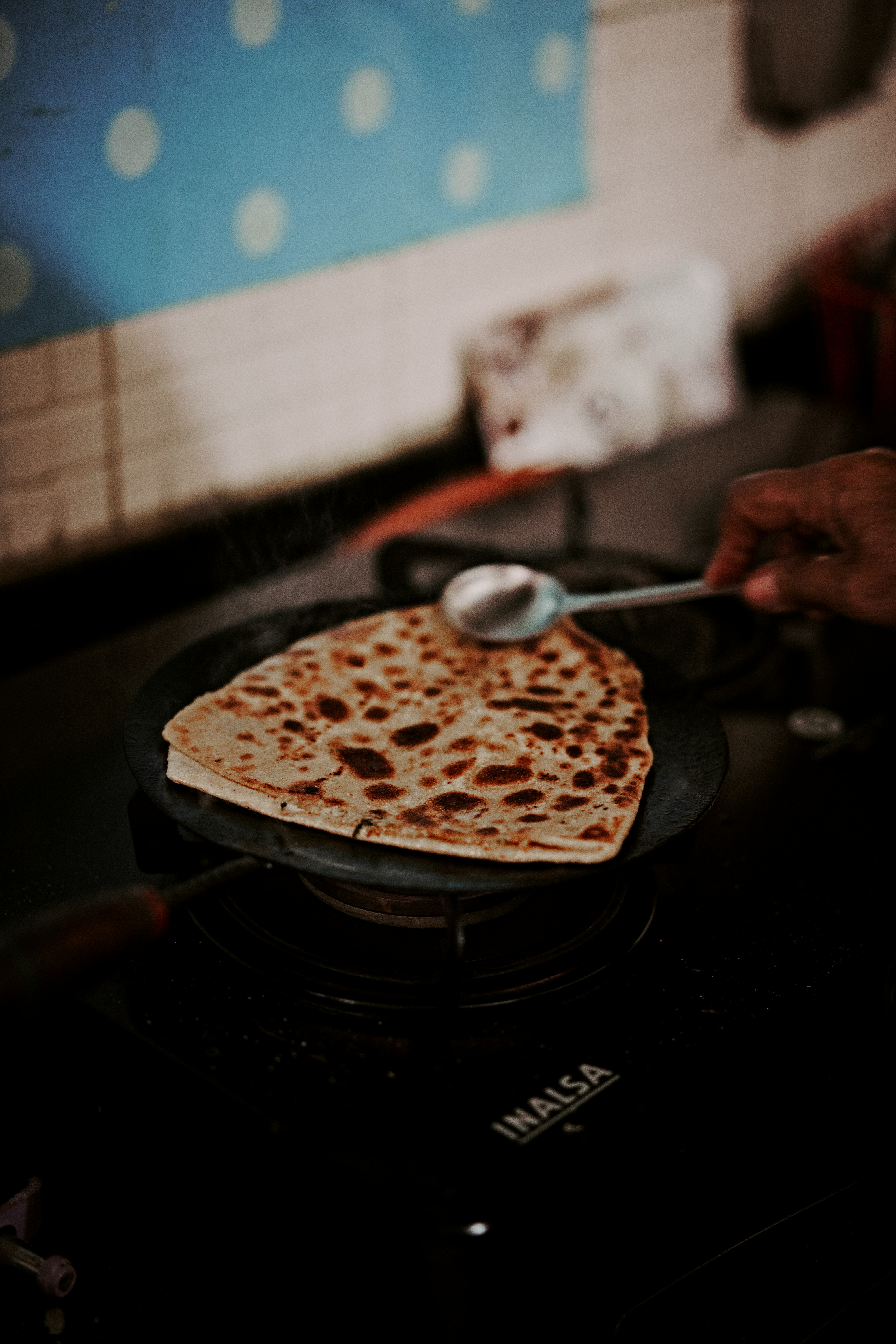 person holding spoon with food on top